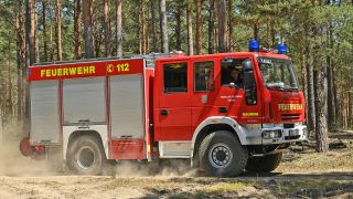 Symboilbild: Ein Löschfahrzeug der Feuerwehr ist zu einem Brand in einem Kiefernwald.(Quelle: Picture-Alliance/Patrick Pleul)