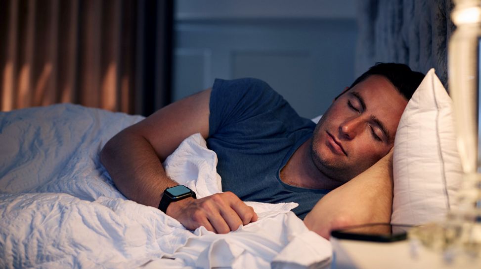 Mann schläft in einem Bett (Bild: imago images/Shotshop)