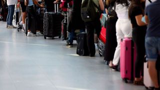 Lange Schlange von Wartenden am Flughafen (Quelle: imago images/Panama Pictures)
