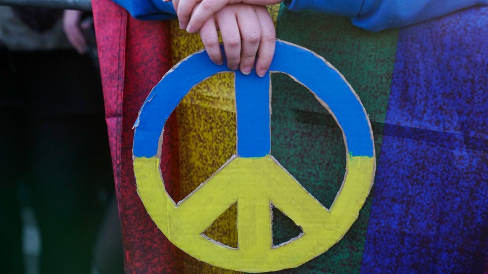 Ein Friedenszeichen in den Farben der Ukraine bei einer Demonstration.