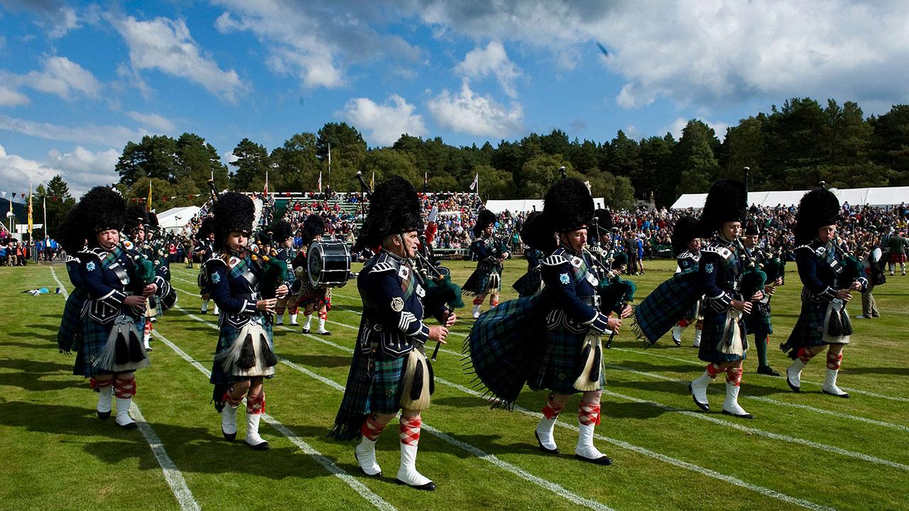 Eine Dudelsack-Band Schottland spielt auf einer Grünfläche (Bild: DPA)