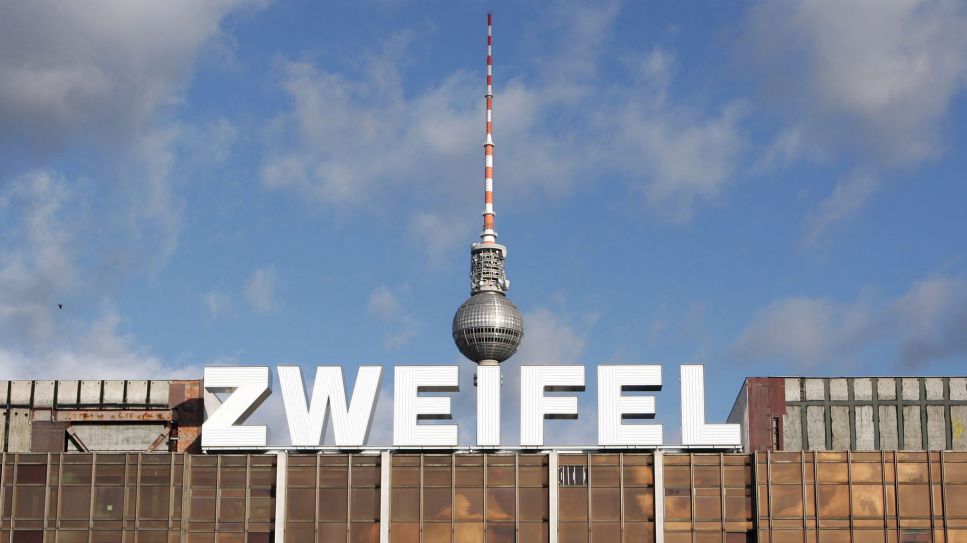 Das Wort "Zweifel" steht in Neon-Buchstaben auf dem Dach des ehemaligen Palastes der Republik in Berlin © dpa/Jens Kalaene