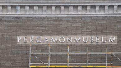 Der Schriftzug "Pergamonmuseum" an der eingerüsteten Fassade des Museums; © dpa/Paul Zinken