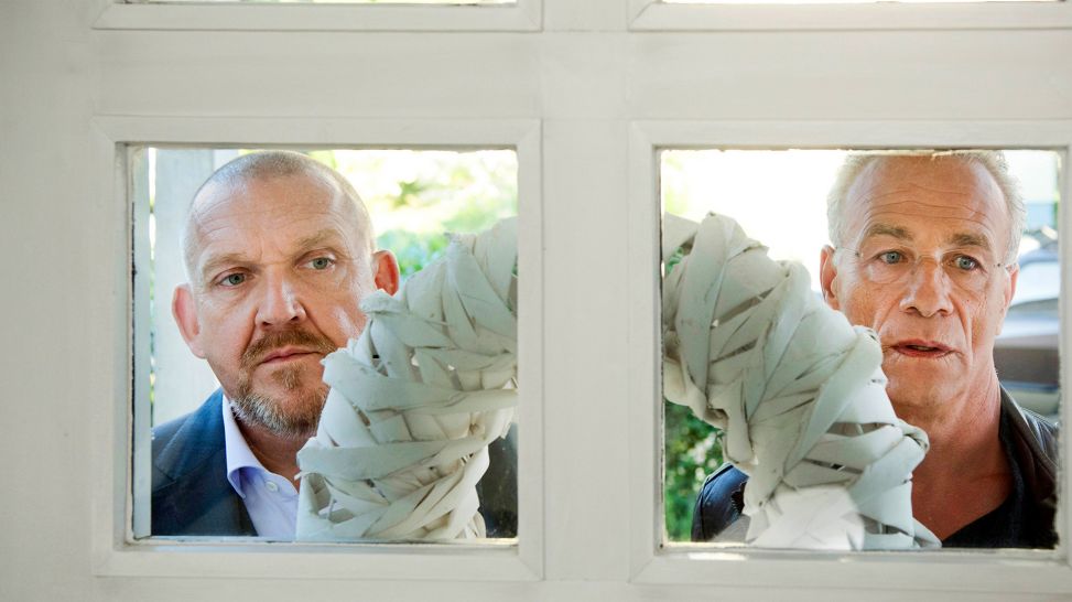 Die Kommissare Freddy Schenk (Dietmar Bär) und Max Ballauf (Klaus J. Behrendt) blicken durch eine Haustür; Quelle: WDR/Martin Menke