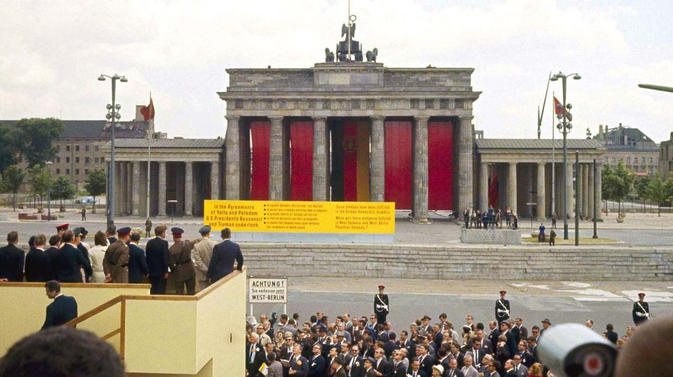 Kennedy an Berliner Mauer, Blick auf verhängtes Brandenburger Tor (Quelle: picture alliance/ASSOCIATED PRESS/Anonymous)