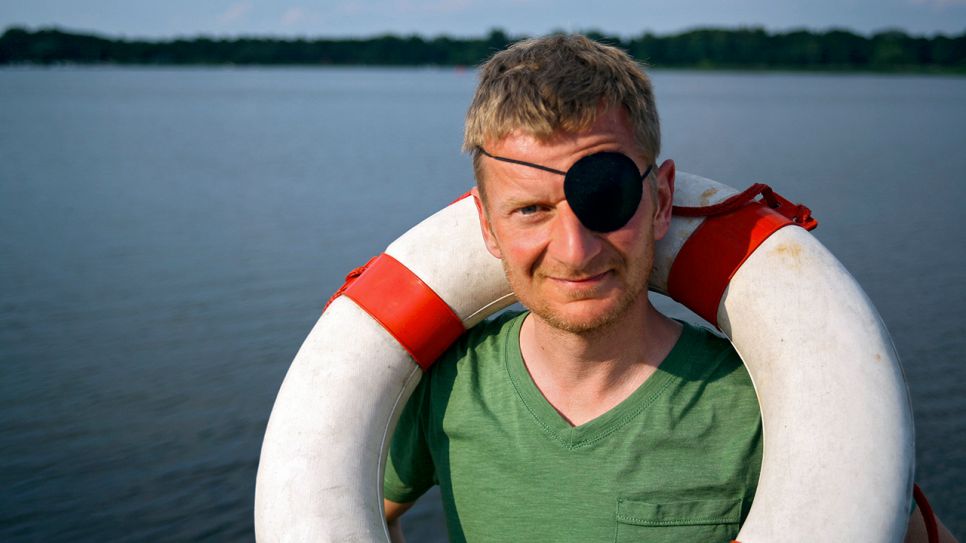 Michael Kessler mit Augenklappe und Rettungsring; Quelle: rbb/Stefan Wieduwilt