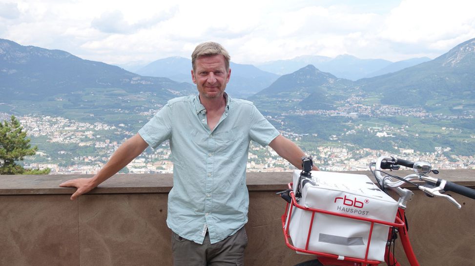 Michael Kessler bei einem Zwischenstopp mit Ausblick auf Trento. Quelle: rbb/Roland Albrecht