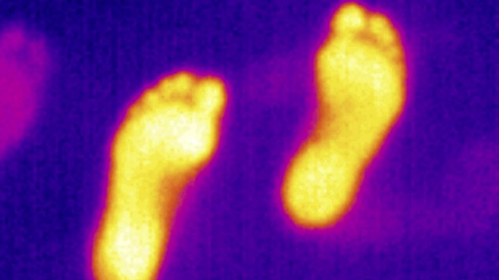 Infrarot-Thermographie: Fußspuren auf einem Teppich strahlen noch Wärme ab (Quelle: imago/Arnulf Hettrich)