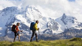 Mann und Frau wandern an Gipfel vorbei (Quelle: imago/imagebroker)
