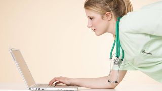 Junge Ärztin arbeitet am Laptop (Quelle: imago/emil umdorf)