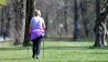 Frau von hinten im Park mit Walkinggstöcken (Bild: imago images/Sven Simon)