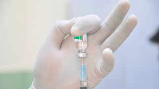 Spritze zieht COVID-19-Impfstoff auf (Bild: imago images/ZUMA Wire)