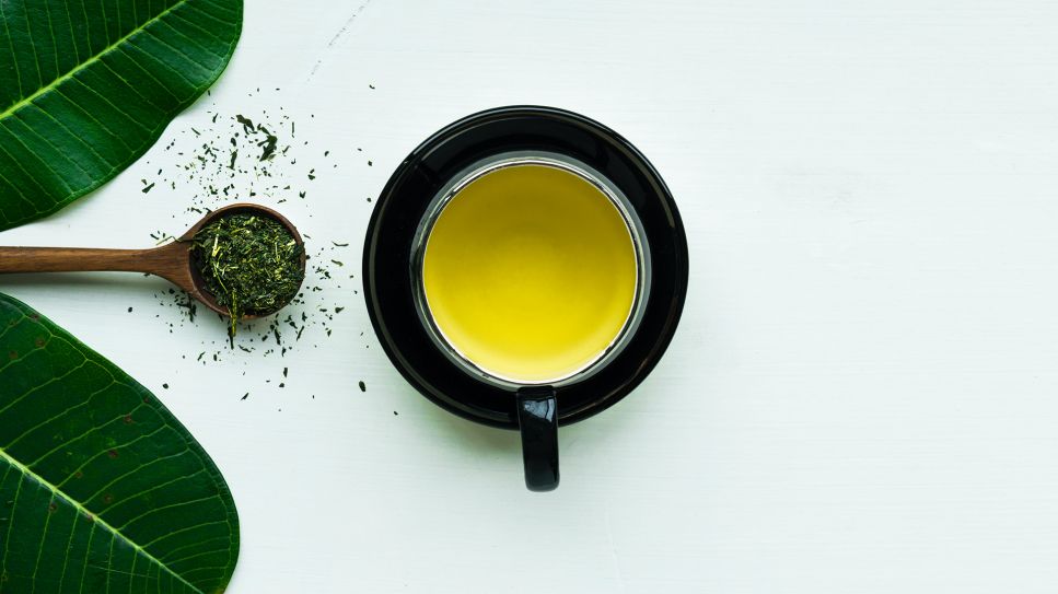 Tasse mit Grünem Tee neben Löffel mit Teeblättern (Bild: unsplash/Rajat Sarki)