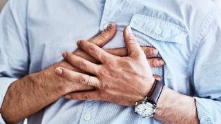 Herzrasen nach Essen: Bild zeigt männlichen Oberkörper mit aufs Herz gelegten Händen (Bild: Imago Images/Zoonar)