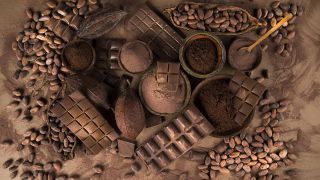 Kakaopulver, -bohnen und Schokolade auf einem Tisch (Bild: imago images/Panthermedia)