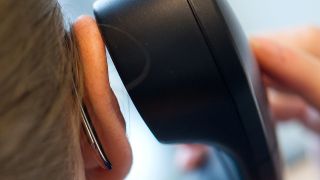 Eine Frau hält einen Telefonhörer ans Ohr. (Quelle: dpa/Franziska Koark)