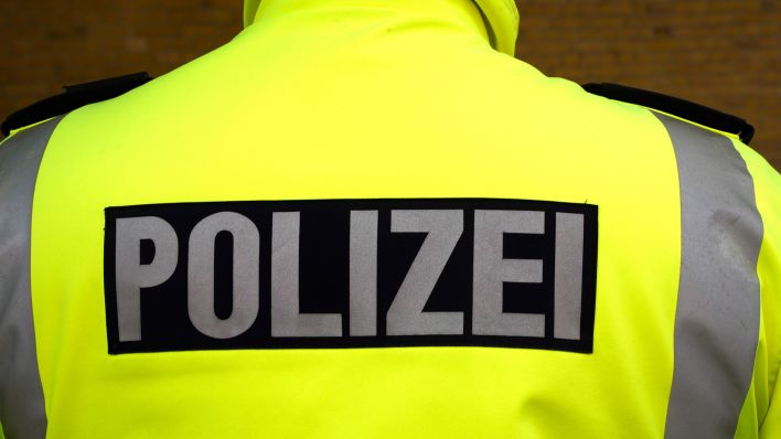 Symbolbild:Polizist mit Warnweste mit Polizeischriftzug.(Quelle:picture alliance/Geisler-Fotopress/T.Bartilla)