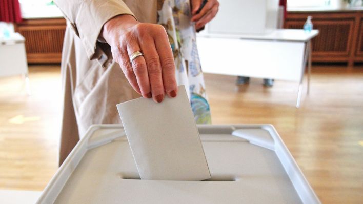 Symbolbild: Frau wirft einen Wahlumschlag in eine Wahlbox.(Quelle: picture alliance/Eibner-Pressefoto/Fleig)