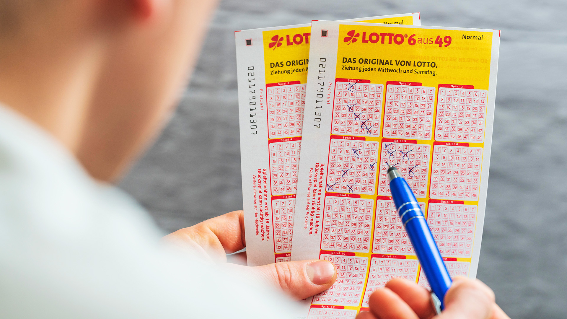 Symbolbild: Jemand macht auf einem Lottoschein mit einem Kugelschreiber seine Kreuze um an der Jackpot Lotterie Teilzunehmen. Glücksspiel Lotto Schein 6 aus 49(Quelle: picture alliance /CHROMORANGE/Michael Bihlmayer)